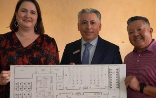 Kelli Rhodes, Restore Education co-founder, president and CEO; Ventura Perez, Bank of America San Antonio president; and Restore Education Board Chair Ric Benitez present a rendering of the San Antonio nonprofit's planned East Side satellite location.