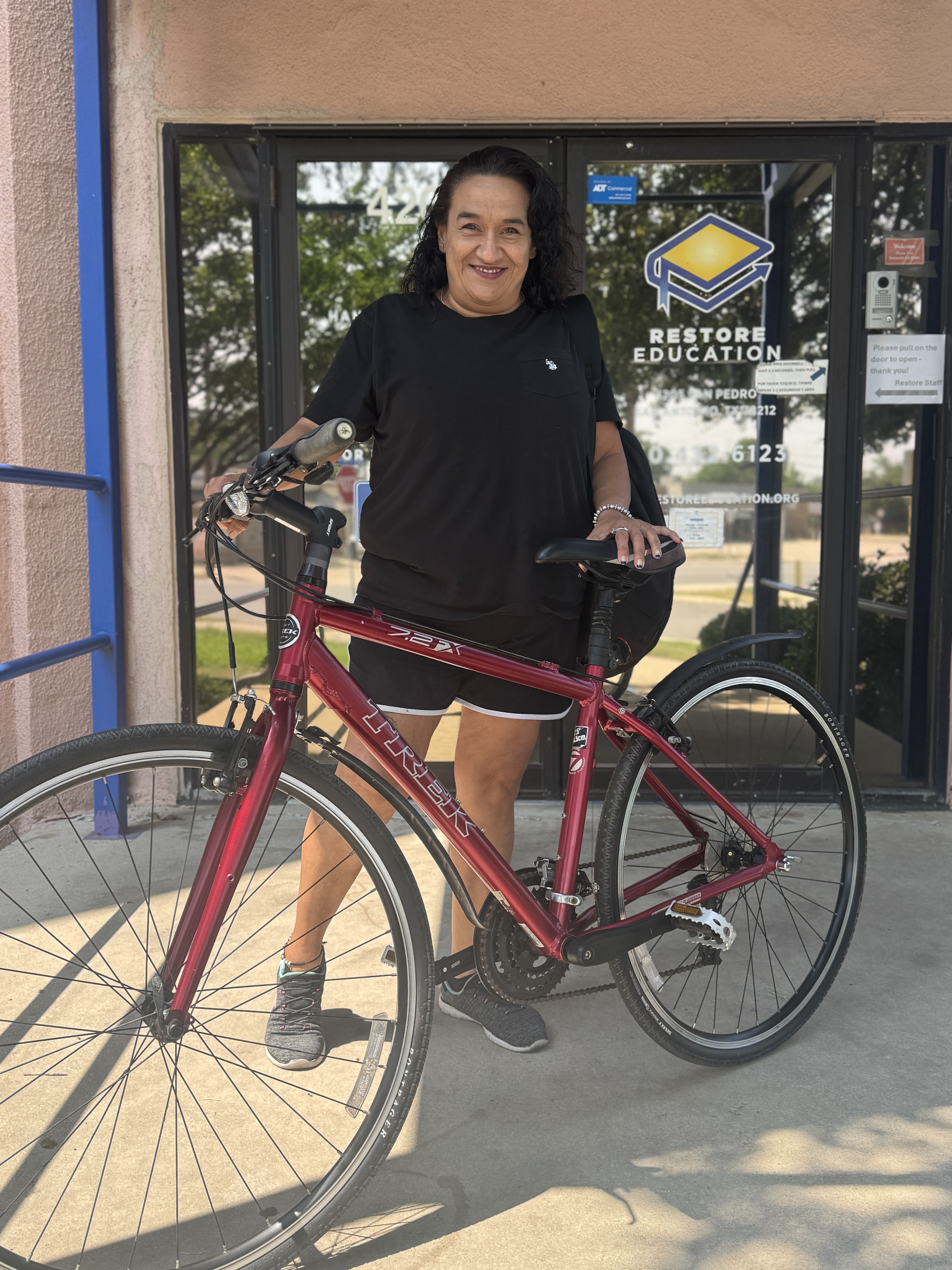 Restore Education student "Melissa G." and her new bicycle.